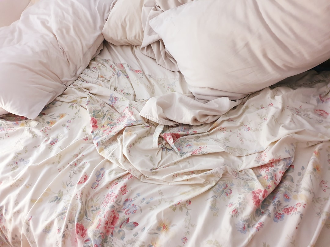 gray apparel beside white sheet