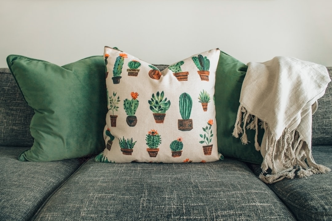 brown throw pillow on white and blue bed linen