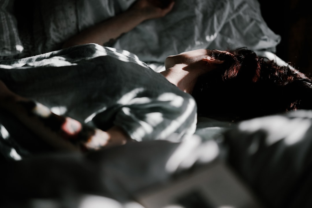 person sleeping on sofa near the wall