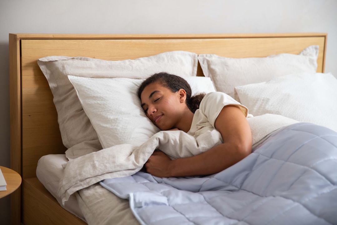 woman in blue shirt lying on bed